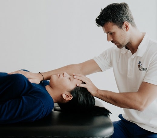 Osteopath giving a gentle manual treatment to a patient